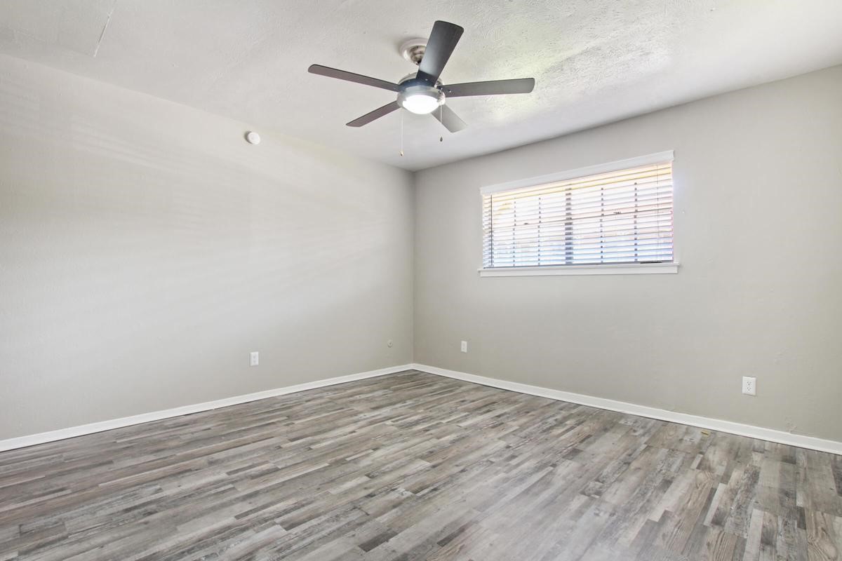 1212 Hampshire Lane, Unit 2091 Richardson, TX 75080 - Photo 2 of 40 an empty room with wooden floor and windows