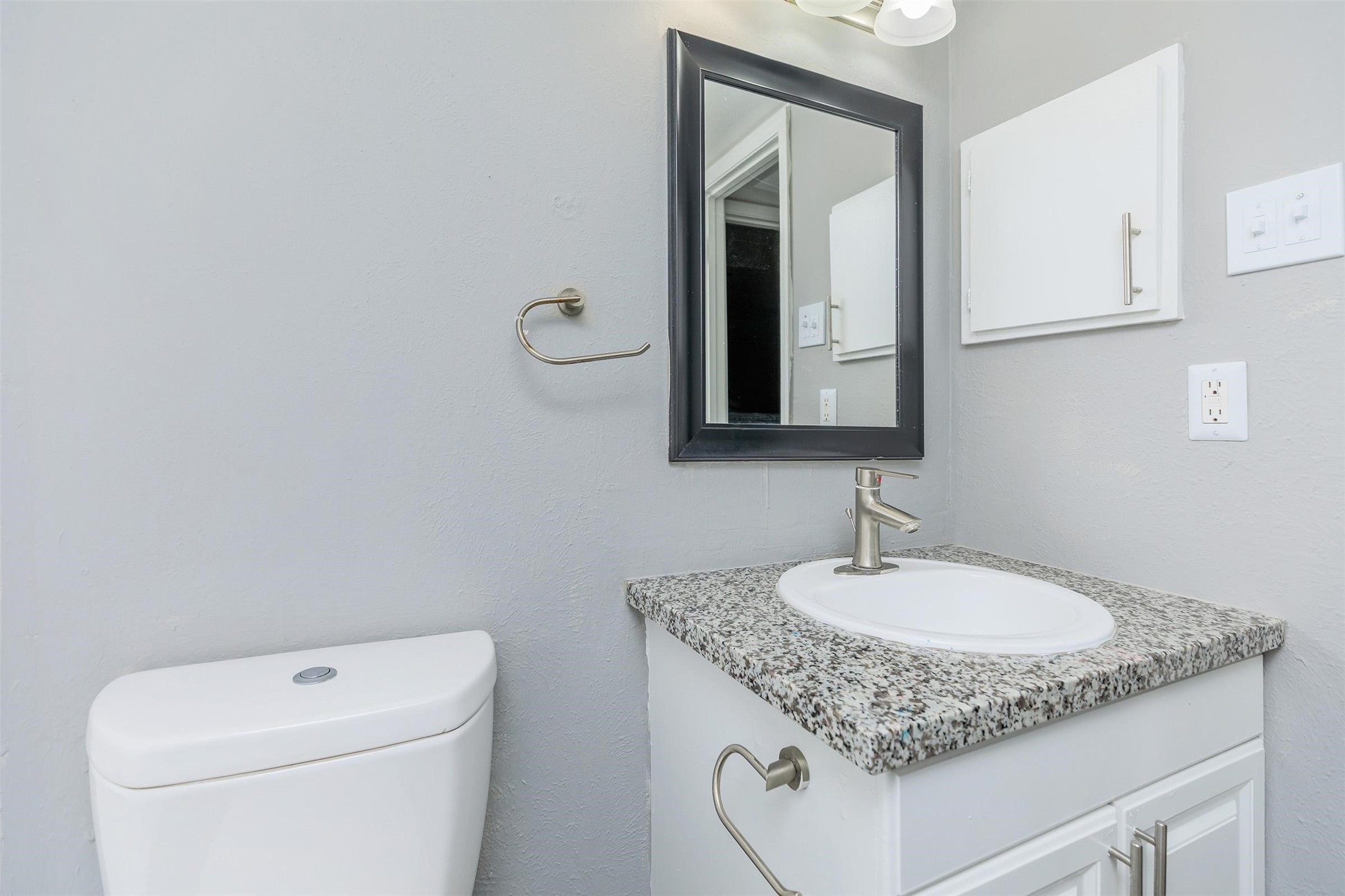 1212 Hampshire Lane, Unit 2091 Richardson, TX 75080 - Photo 20 of 40 a bathroom with a granite countertop sink and a toilet