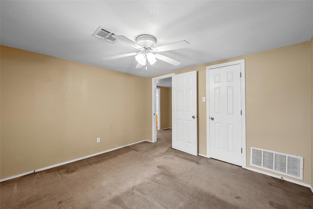 4704 Williams Road Bellmead, TX 76705 - Photo 19 of 32 Carpeted room with a ceiling fan, light beige walls, and white trim