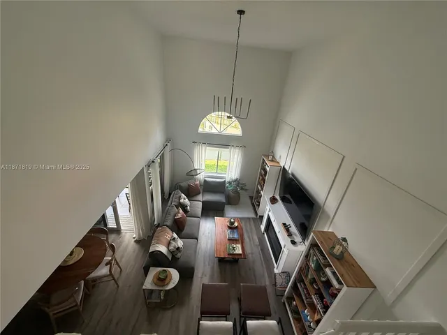 a view of a dining room with furniture wooden floor and chandelier