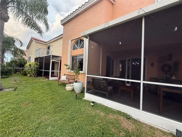 a view of a patio with a table and chairs