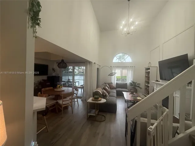 a room with lots of furniture and a chandelier