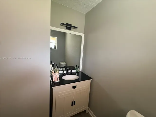 a bathroom with a sink and mirror