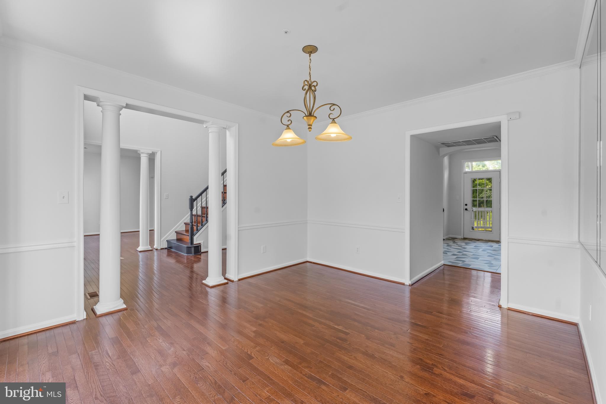 601 James Ridge Road Bowie, MD 20721 - Photo 24 of 77 an empty room that has a chandelier and wooden floor