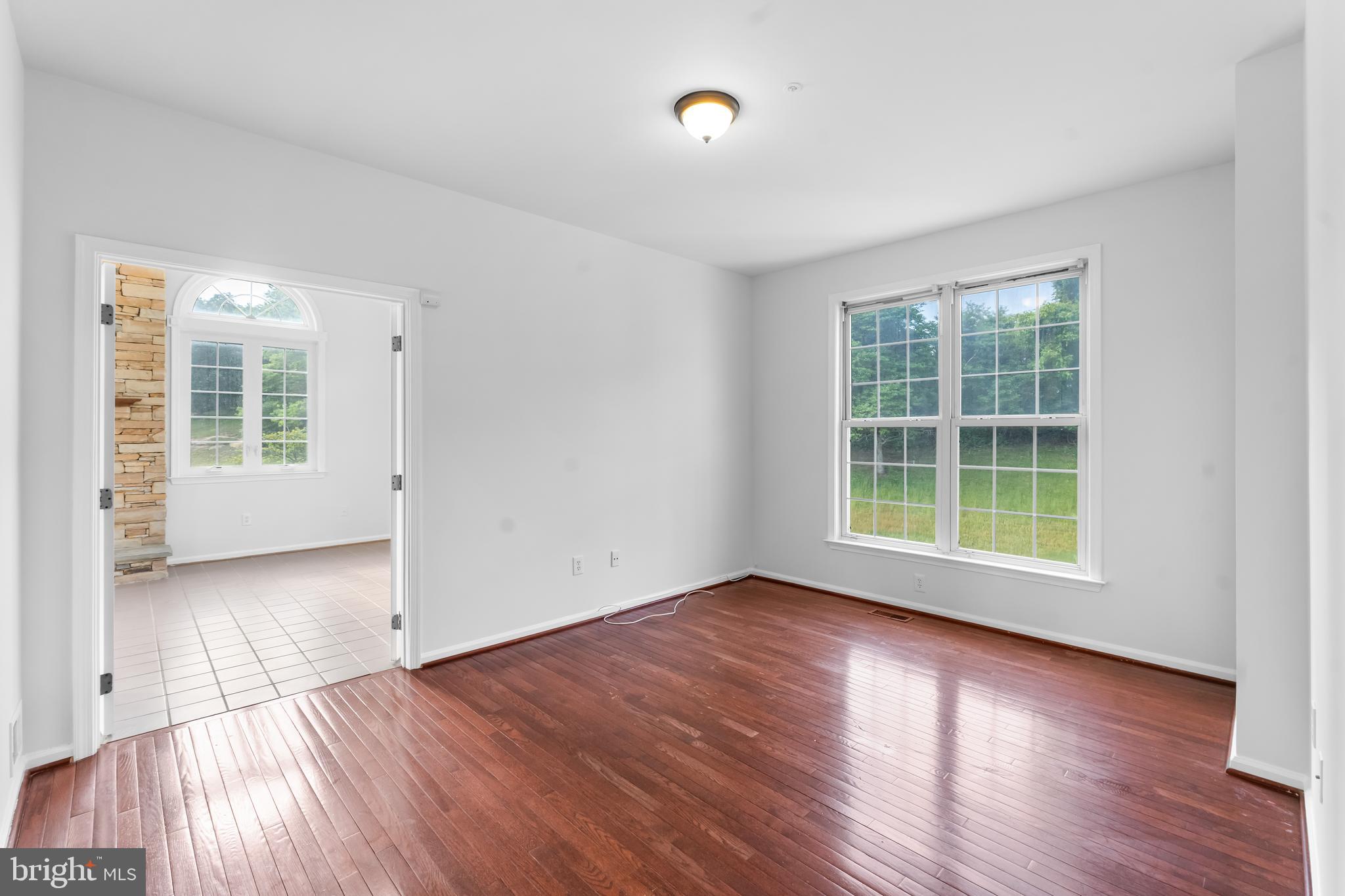 601 James Ridge Road Bowie, MD 20721 - Photo 29 of 77 an empty room with wooden floor and windows