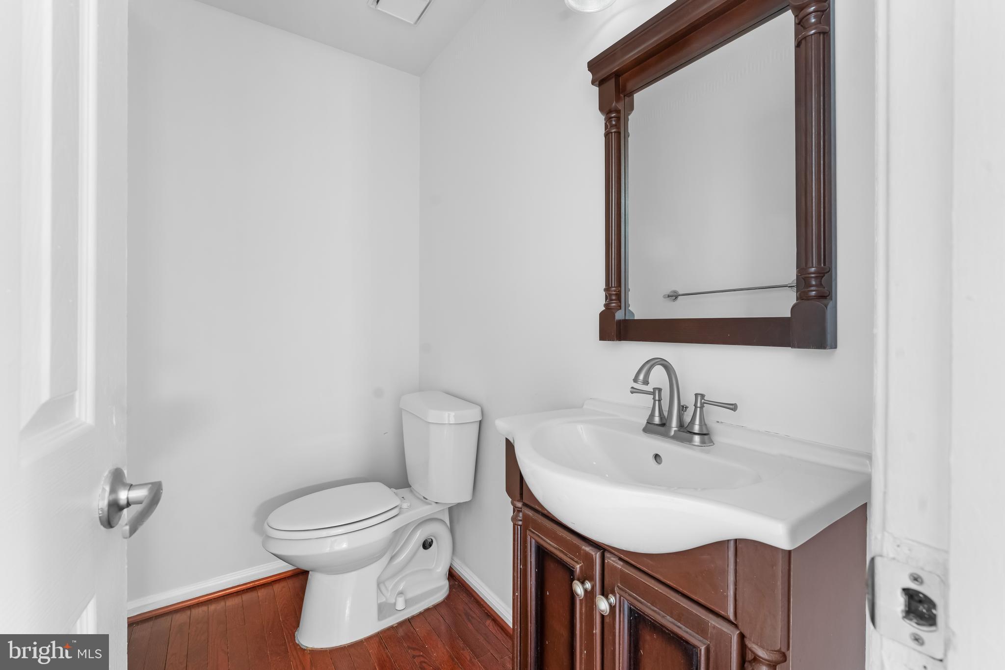 601 James Ridge Road Bowie, MD 20721 - Photo 36 of 77 a bathroom with a toilet sink and mirror