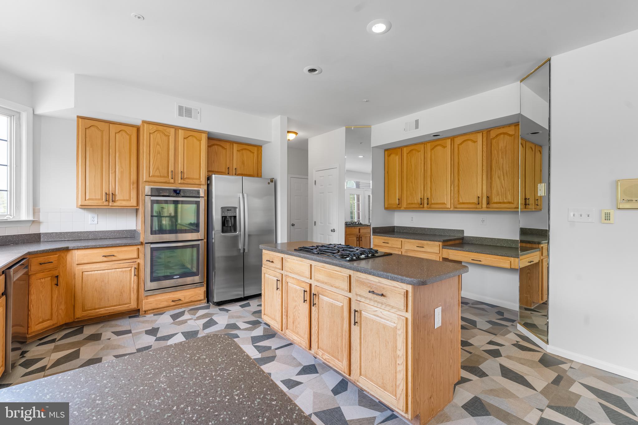 601 James Ridge Road Bowie, MD 20721 - Photo 39 of 77 a kitchen with stainless steel appliances granite countertop a refrigerator and a stove top oven