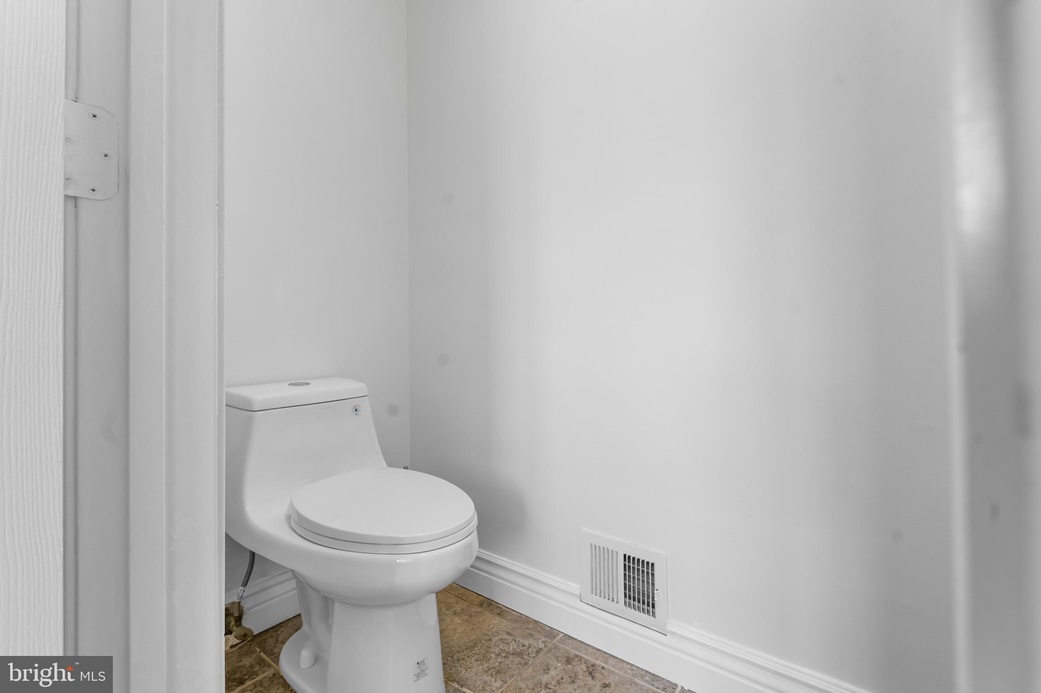 601 James Ridge Road Bowie, MD 20721 - Photo 51 of 77 a white toilet sitting next to a white wall