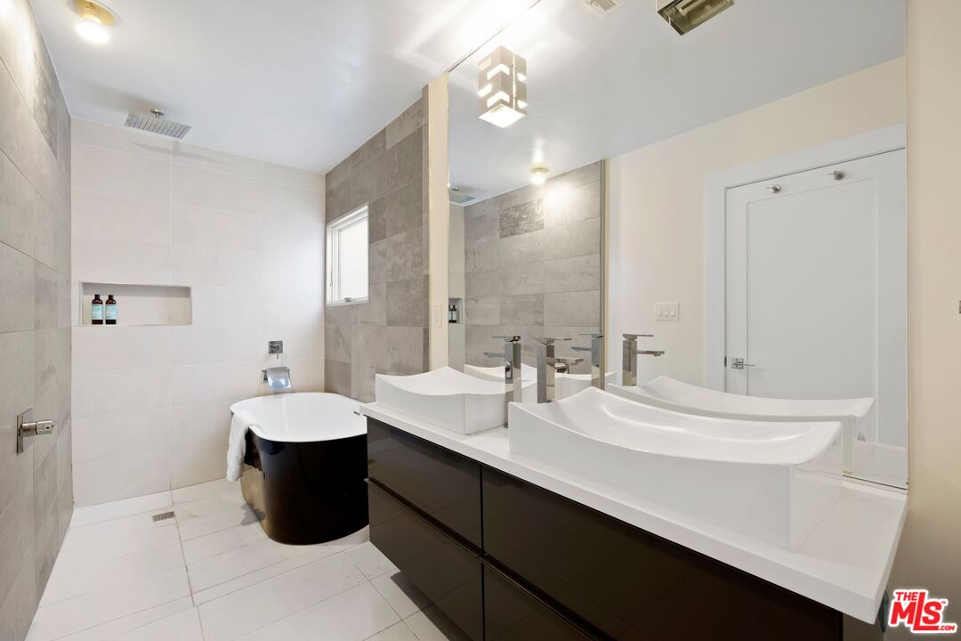 967 Vernon Avenue Venice, CA 90291 - Photo 14 of 22 a bathroom with a sink and a mirror