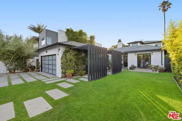 a view of a house with a yard and a patio