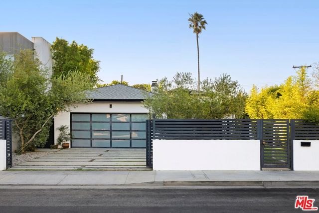 a view of a house with a yard and table and chairs