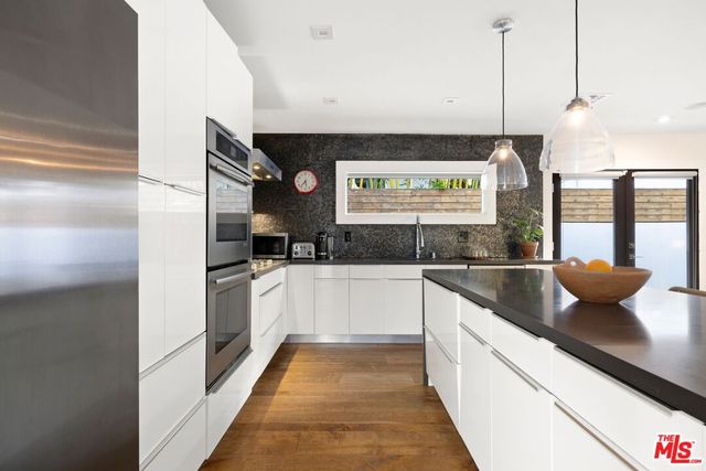 a kitchen with stainless steel appliances a refrigerator and a stove