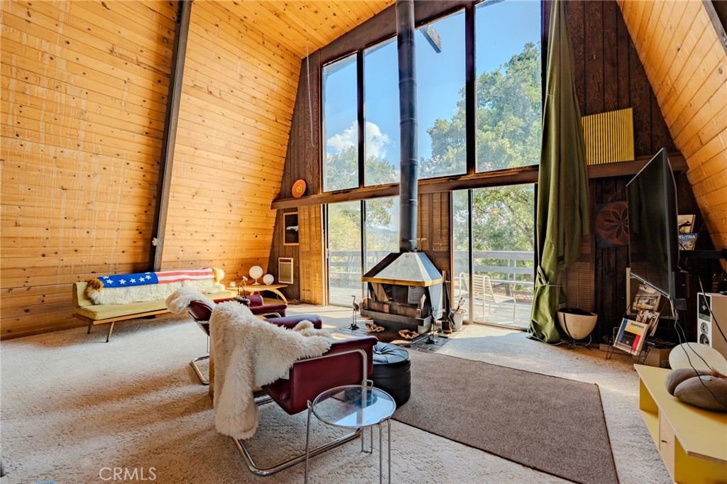 27380 Deertrail Drive Tehachapi, CA 93561 - Photo 12 of 47 a living room filled with furniture and a floor to ceiling window