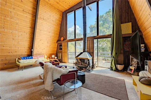 a living room filled with furniture and a floor to ceiling window