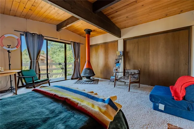 a bedroom with furniture and large windows