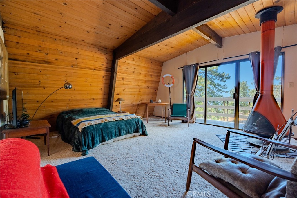 27380 Deertrail Drive Tehachapi, CA 93561 - Photo 19 of 47 a bedroom with a bed and large windows