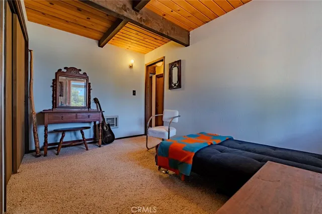 a bedroom with a bed and a desk