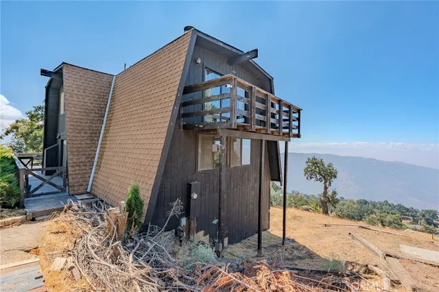 a view of a house with wooden fence