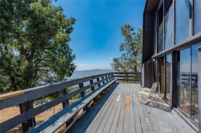 a view of balcony with wooden floor and fence