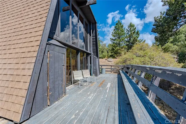 a balcony view with wooden floor and fence
