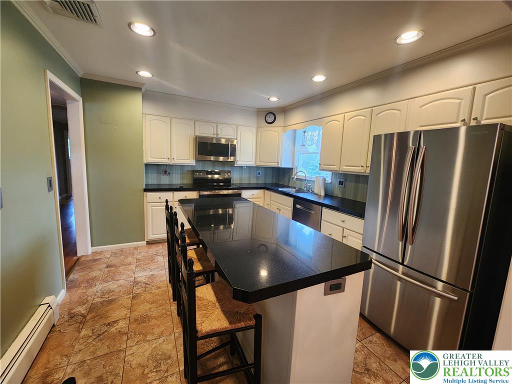 1480 Teels Road Pen Argyl, PA 18072 - Photo 11 of 18 Granite counters and stainless steel appliances anchor this kitchen featuring a central breakfast island.