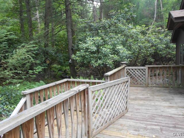 3497 Spruce Cabin Road Cresco, PA 18326 - Photo 17 of 22 a balcony with wooden floor and trees