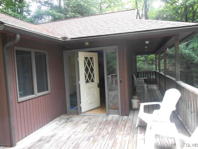 3497 Spruce Cabin Road Cresco, PA 18326 - Photo 2 of 22 a backyard of a house with table and chairs
