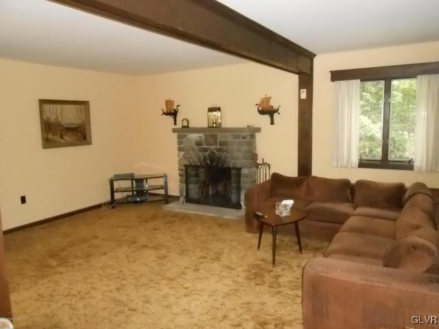 3497 Spruce Cabin Road Cresco, PA 18326 - Photo 3 of 22 a living room with furniture and a fireplace