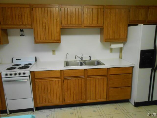 3497 Spruce Cabin Road Cresco, PA 18326 - Photo 8 of 22 a kitchen with stainless steel appliances granite countertop a sink a stove and a refrigerator