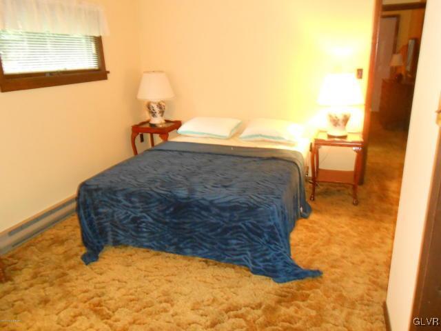 3497 Spruce Cabin Road Cresco, PA 18326 - Photo 9 of 22 a bedroom with a bed and chair