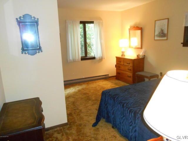 3497 Spruce Cabin Road Cresco, PA 18326 - Photo 10 of 22 a bedroom with a bed and wooden floor