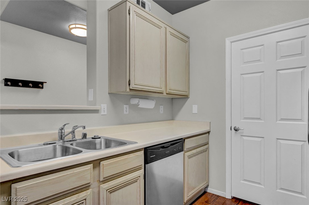 7147 South Durango Drive, Unit 304 Las Vegas, NV 89113 - Photo 7 of 27 Kitchen featuring dishwasher, wood finished floors, light countertops, and cream cabinets