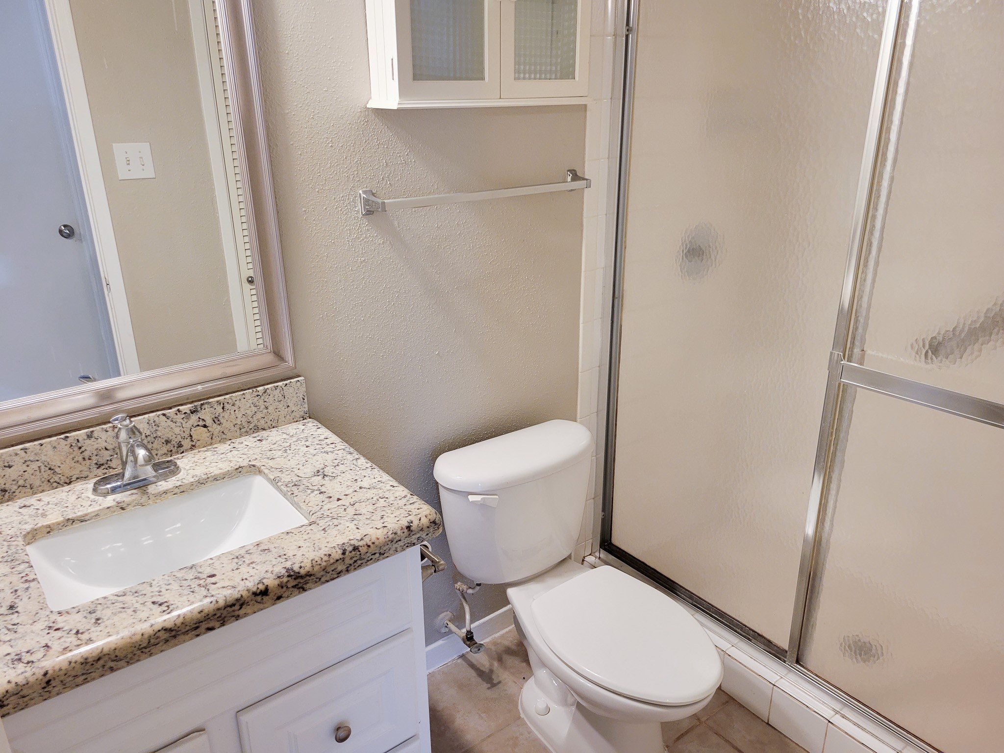 4041 Drake Street, Unit 116 Houston, TX 77005 - Photo 20 of 27 a white toilet sitting next to a bathroom sink