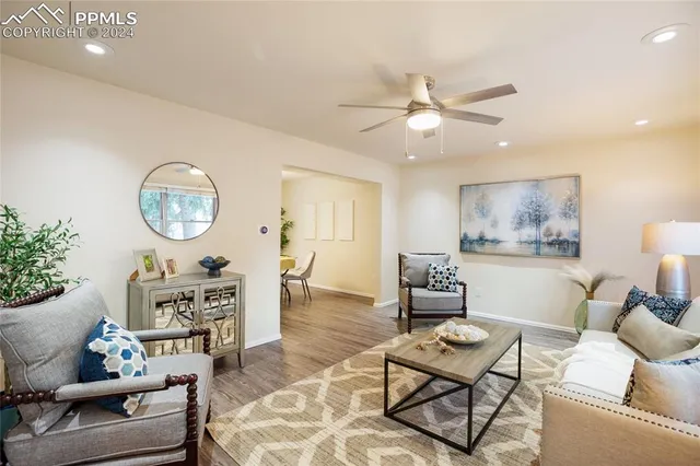 a living room with furniture and a chandelier