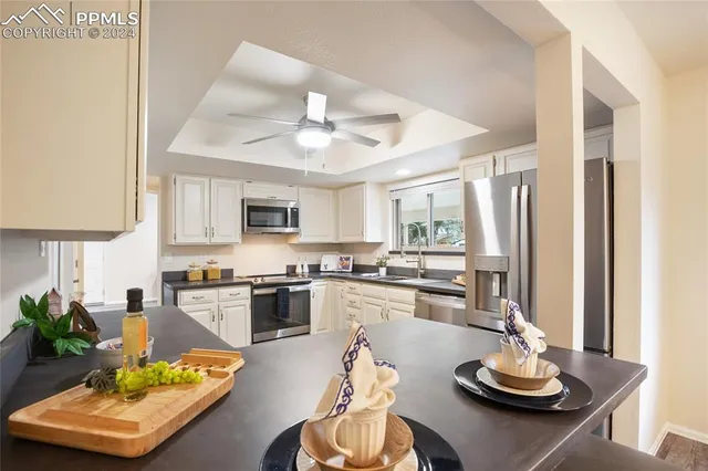 a kitchen with stainless steel appliances granite countertop a sink a stove and a refrigerator