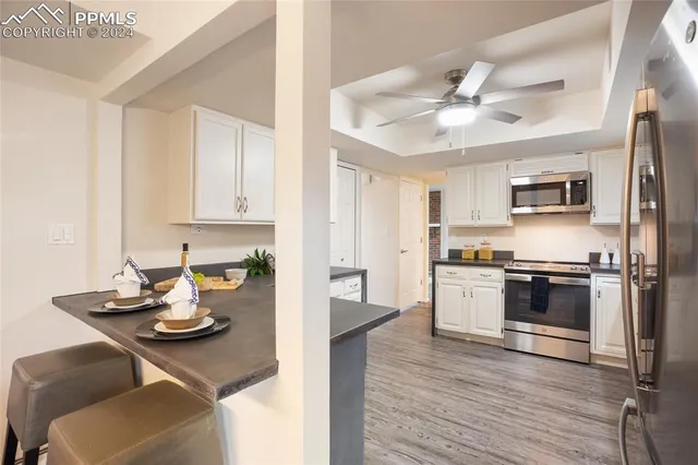 a kitchen with stainless steel appliances granite countertop a sink dishwasher stove top oven and refrigerator