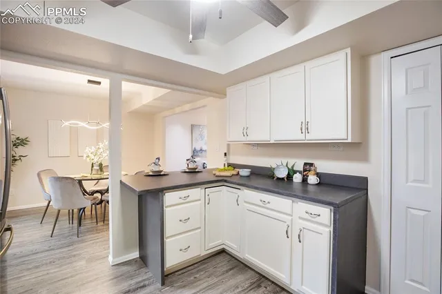 a kitchen with a sink cabinets and wooden floor