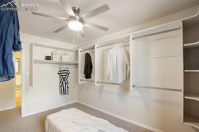 a view of a livingroom with furniture ceiling fan and window