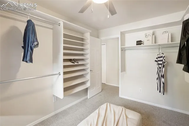 a view of walk in closet with empty racks