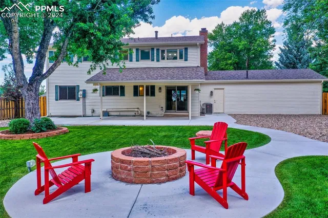 a house view with a seating space and garden