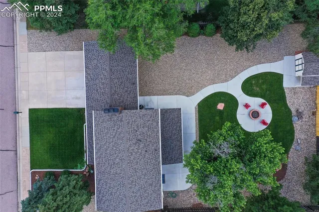 a aerial view of a house with table and chairs