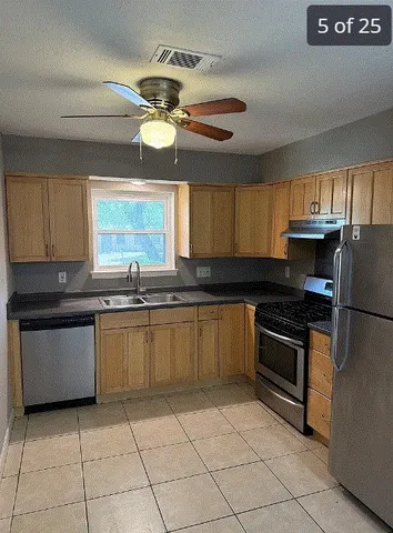 a kitchen with a sink cabinets and window