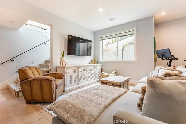 a bedroom with furniture and a flat screen tv