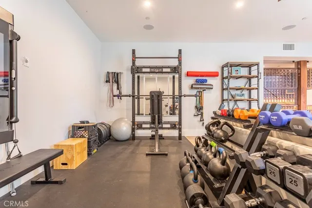 a room with gym equipment and air hockey table