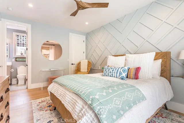 a bathroom with a granite countertop sink a toilet and a shower
