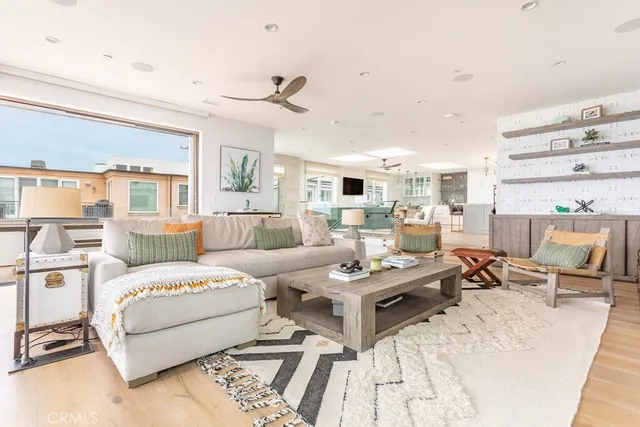 a bedroom with a bed a couch and large window