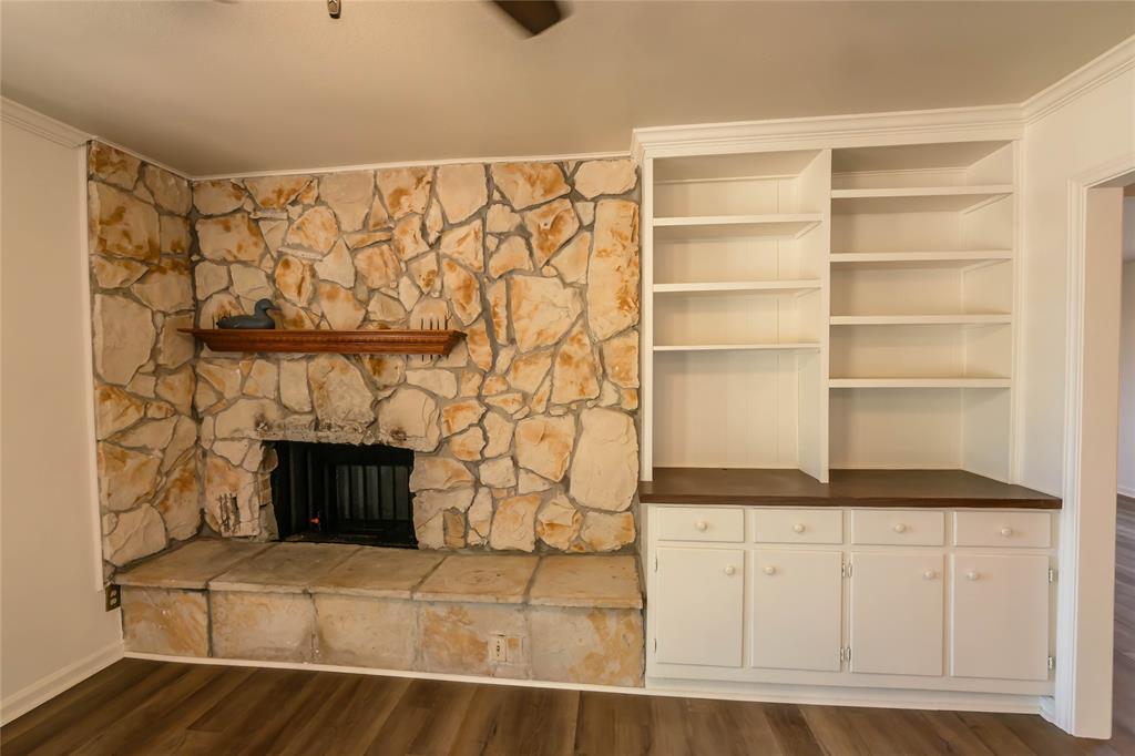 1226 Clay Street Nocona, TX 76255 - Photo 11 of 31 a living room with a rug and a fireplace