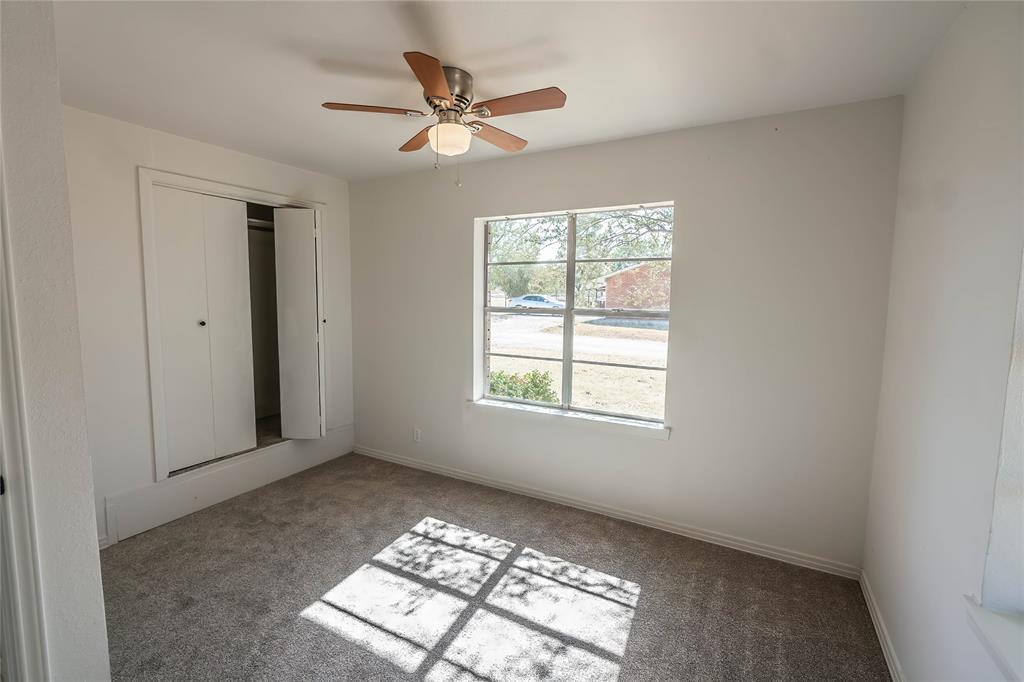 1226 Clay Street Nocona, TX 76255 - Photo 15 of 31 an empty room with windows and fan