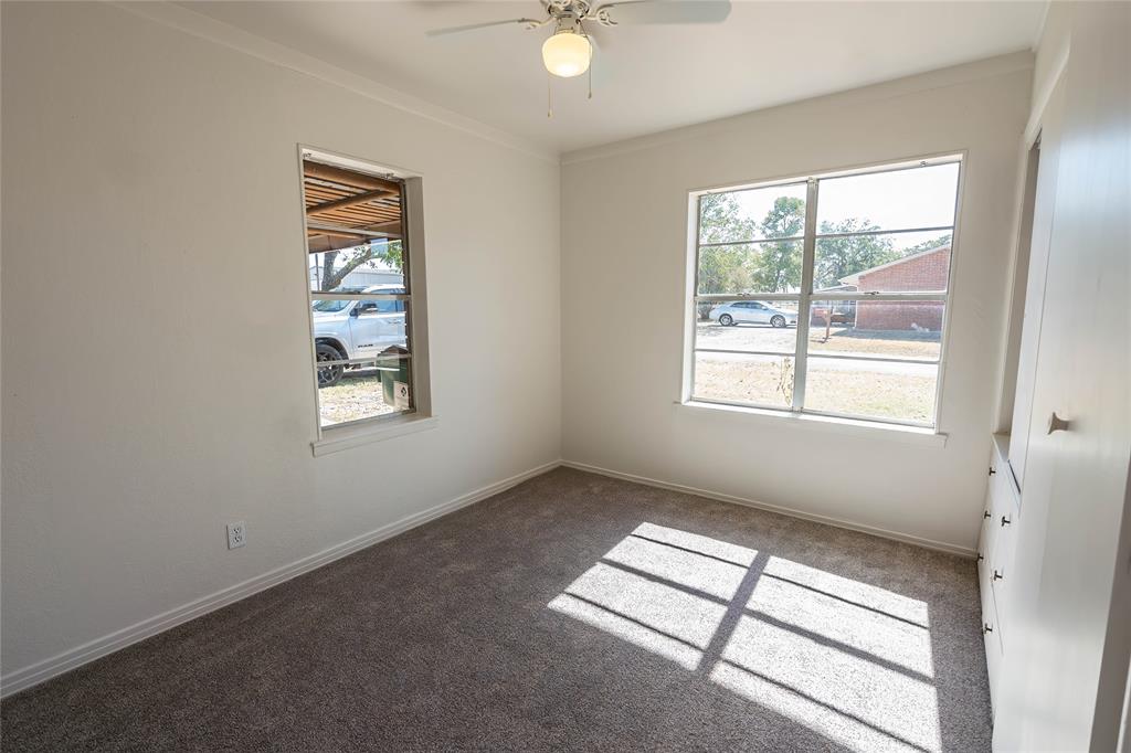 1226 Clay Street Nocona, TX 76255 - Photo 17 of 31 an empty room with windows and closet