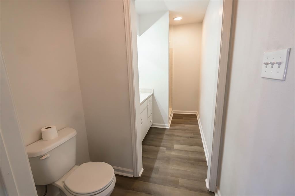 1226 Clay Street Nocona, TX 76255 - Photo 18 of 31 a bathroom with a toilet and a shower